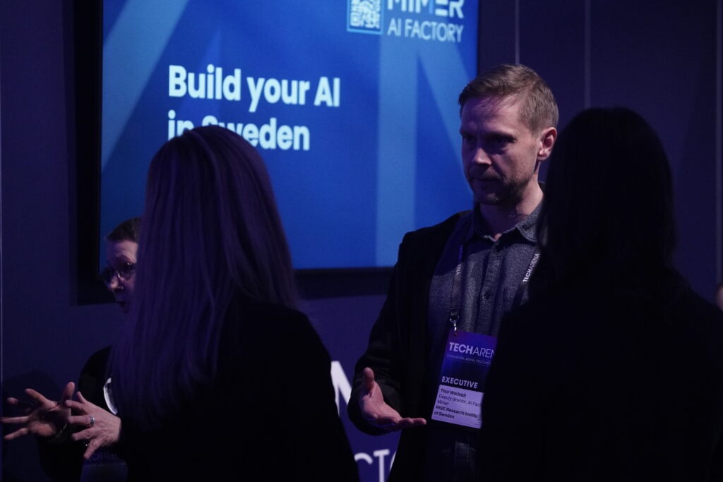 Mimer AI Factory representative presenting AI infrastructure in front of a “Build your AI in Sweden” screen at TechArena 2026.