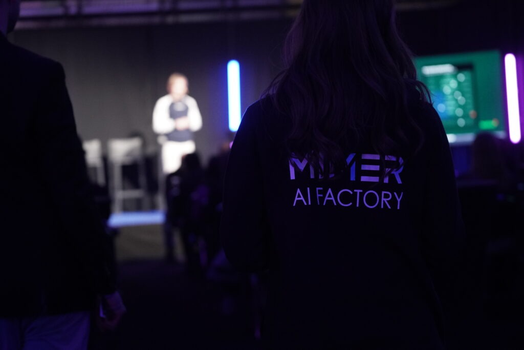 Mimer AI Factory team member watching a presentation during the TechArena 2026 side event.