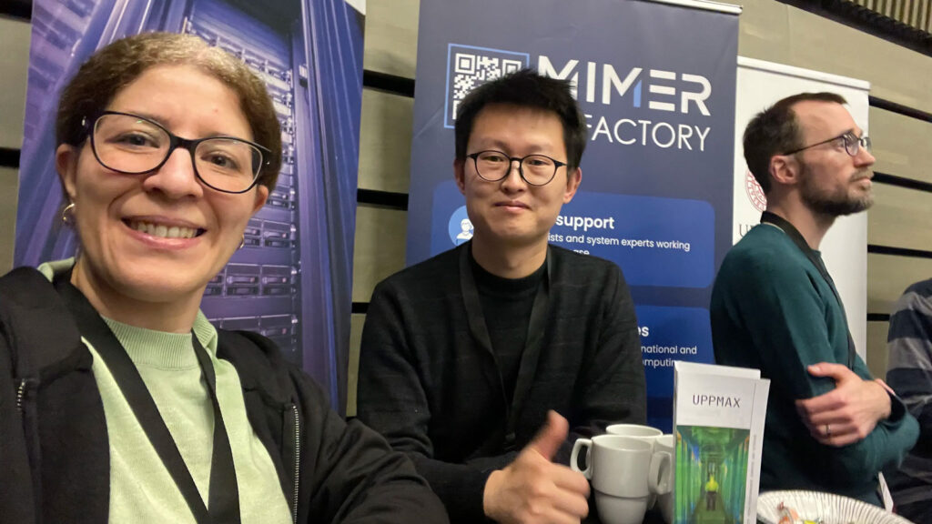 Three happy people in front of roll-ups