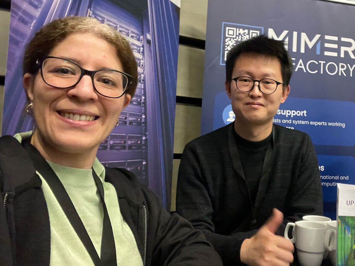 Three happy people in front of roll-ups